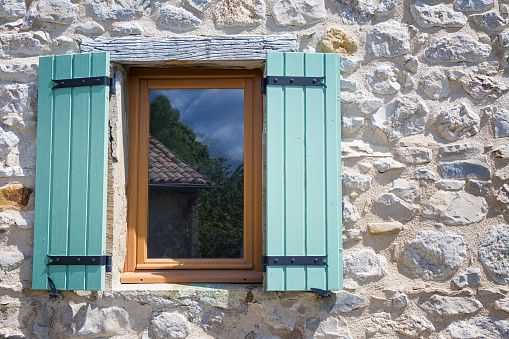Window with shutters in an old house in Provence. France.
