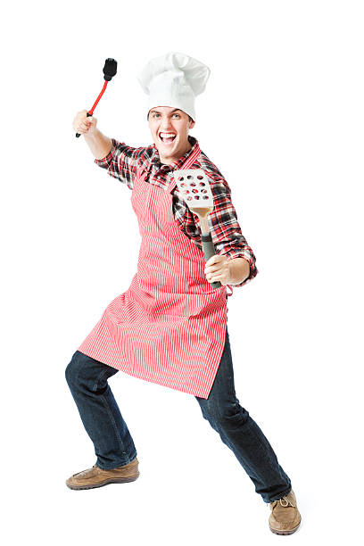 Handsome young Hispanic chef giving the thumbs up to one of his dishes at a restaurant