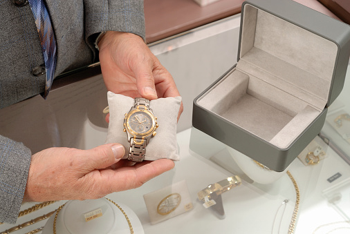Salesman showing a luxury wristwatch at jewelry´s store. More from this jewelry store in the lightbox: