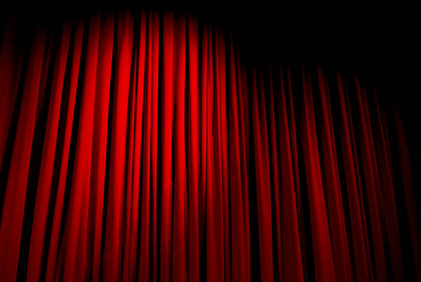 istock Red velvet curtain closed with a spotlight on it 172363089