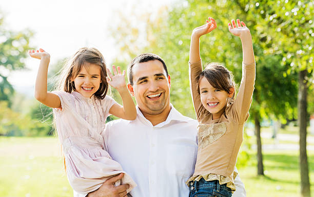 istock Father with his beautiful daughters in park. 172363265