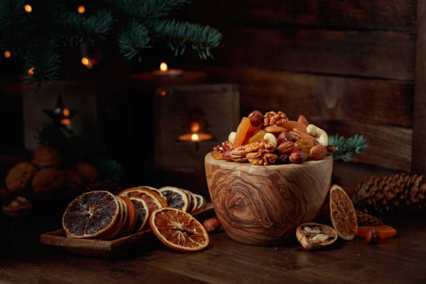 istock Dried fruits and assorted nuts on an old wooden table. 1723634446