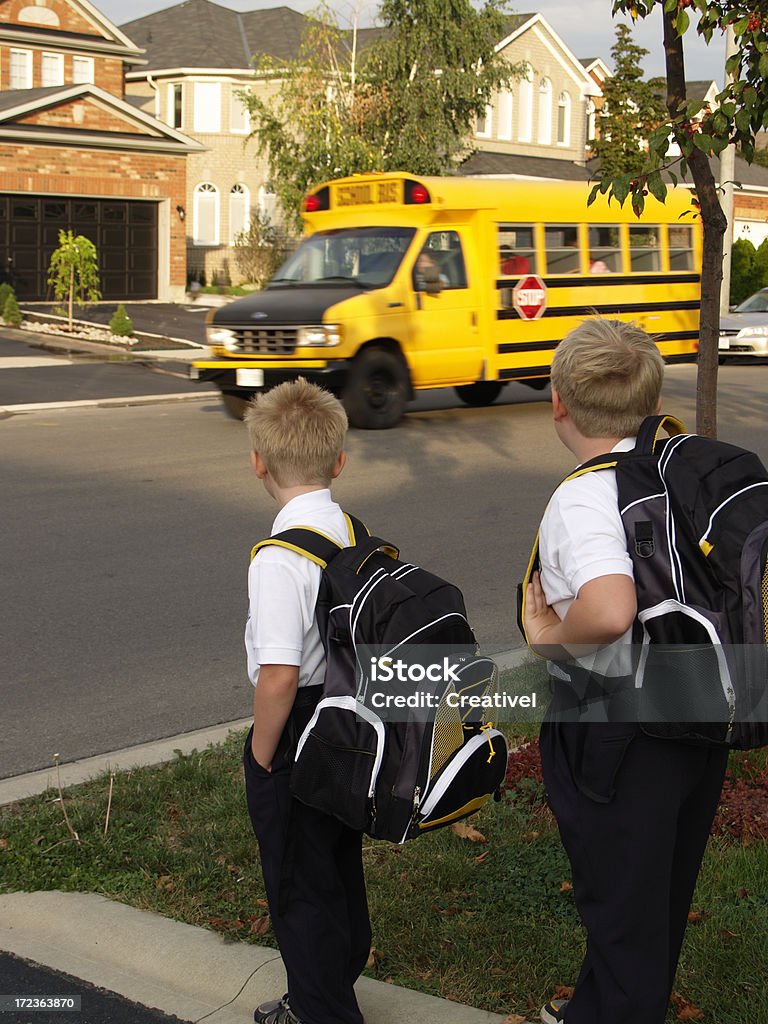 Going to school boys waiting for school bus Boys Stock Photo
