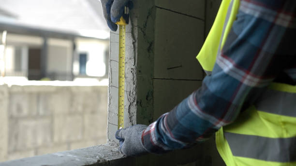 istock Close up hand architect asian using  level measuring instrument to install window Construction home site. Asian worker using level on a construction site. 1723638771