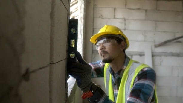 istock Close up hand blur architect asian using water level measuring instrument to install window Construction home site. 1723639958