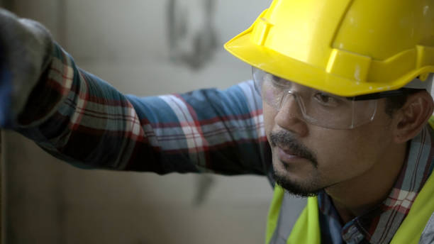 istock Close up architect asian using water level measuring instrument to install window Construction home site. 1723641599