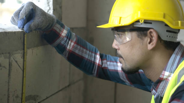 istock Close up architect asian using  level measuring instrument to install window Construction home site. 1723641602