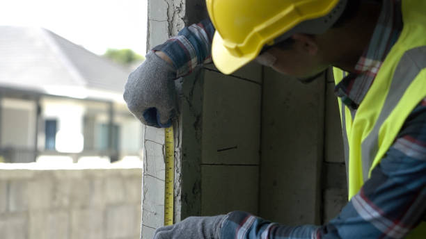 istock Close up hand architect asian using  level measuring instrument to install window Construction home site. Asian worker using level on a construction site. 1723641846