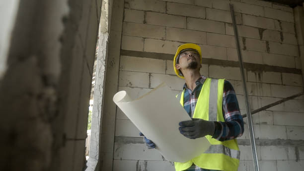 istock Asian architect reviewing blueprints in the project Construction home  at Construction site. 1723642129
