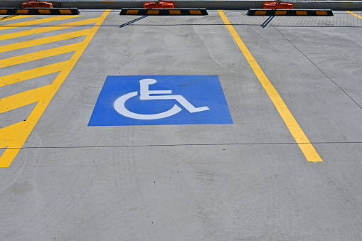 Blue and white symbol on a disabled parking spot