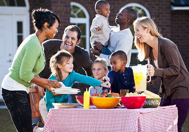 Neighbors having picnic Two families with children having picnic. neighbour stock pictures, royalty-free photos & images