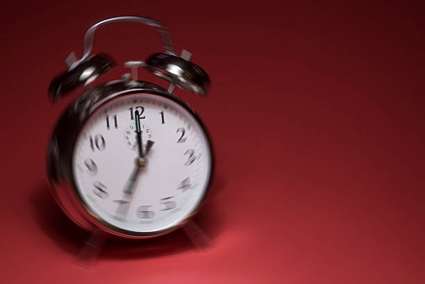 Ringing alarm clock on red background stock photo