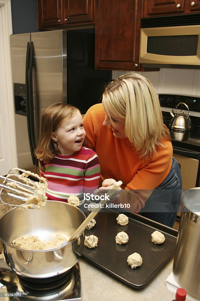 Cooking Lesson A mother and daughter bake together Adult Stock Photo
