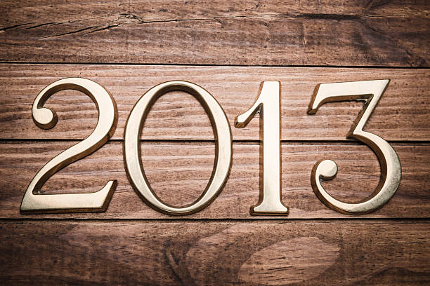 istock 2013 gold numbers on wood background 172367373