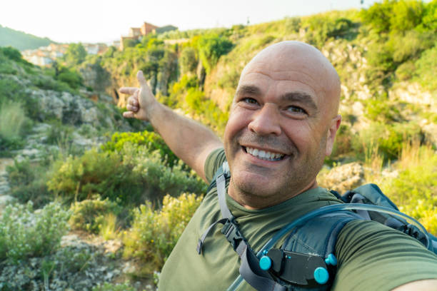 istock Happy hiker man takes a selfie in the forest 1723676335