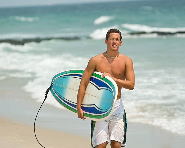 istock Fit Young Surfer Walks the Beach 172367942