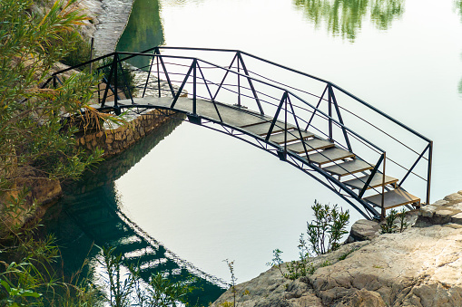 Small metallic bridge over the water in a lake