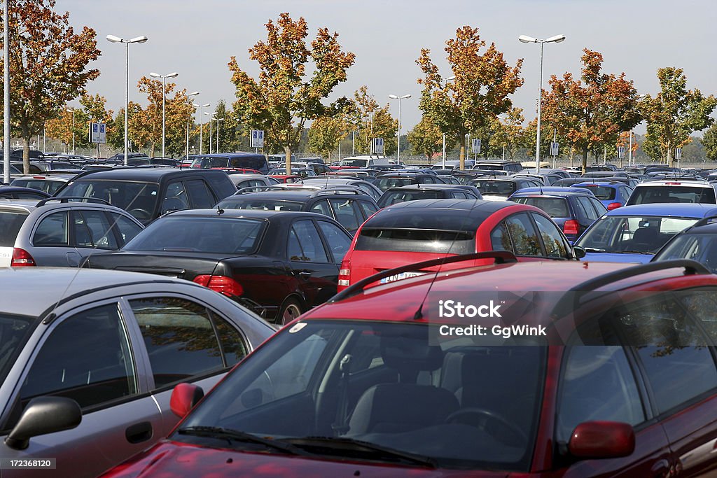 The tops of many rows of cars in a parking lot with trees Car park in autumn landscape. Similar Photo ... Parking Lot Stock Photo