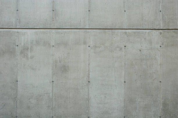 Raw New Concrete Wall Background with Texture Fresh new concrete wall background with construction formwork lines and tie hole plugs concrete wall stock pictures, royalty-free photos & images