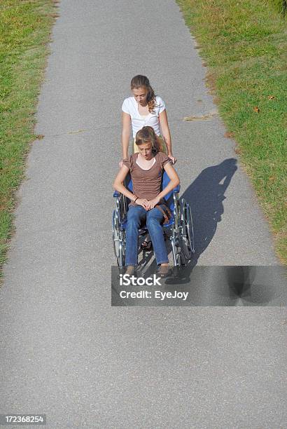 Ayudar A Foto de stock y más banco de imágenes de Silla de ruedas - Silla de ruedas, Vista elevada, Adolescente