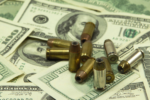 Bullets on a one hundred dollar bill background.
