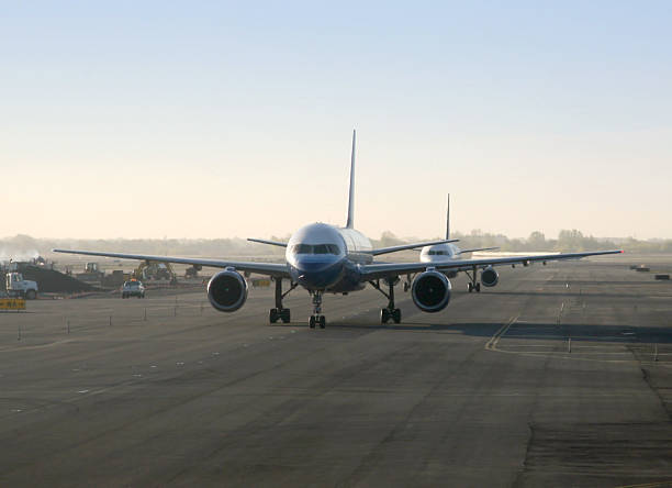 Airplanes Taxiing On Runway stock photo