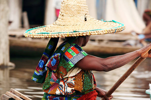 african woman on boat ganvie, benin. benin stock pictures, royalty-free photos & images