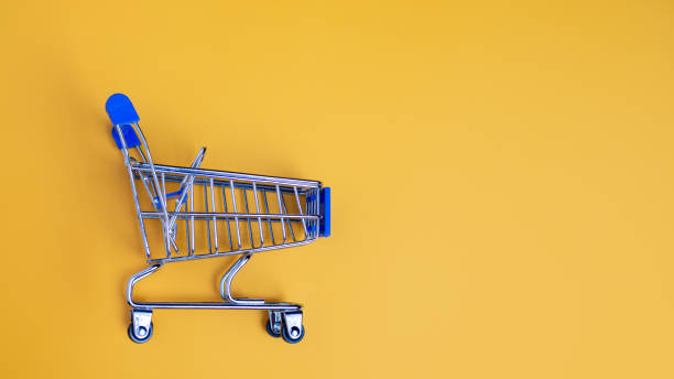 istock Shopping cart on yellow background with light and shadow. schopping concept. 1723694726