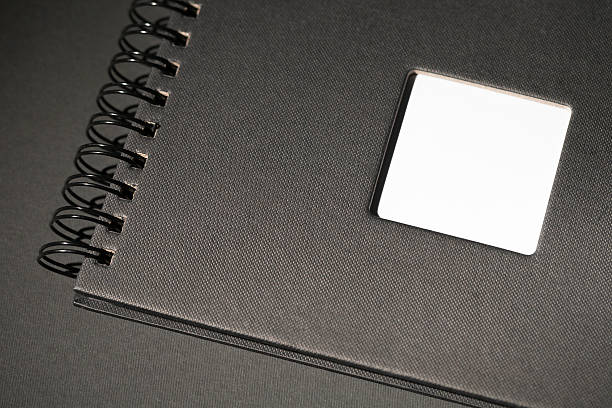 photo album black photo album / spiral notebook on black background old black leather photo album stock pictures, royalty-free photos & images
