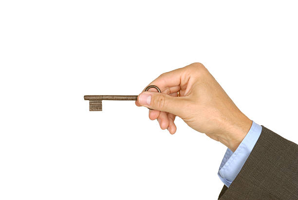 Male holding door key stock photo