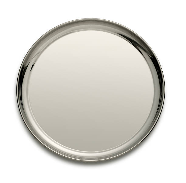 Silver tray isolated on a white backgtound A round silver tray isolated on a white background. A light gray tone across the serving tray allows ample room for copy. A soft shadow sits under the tray. tray stock pictures, royalty-free photos & images