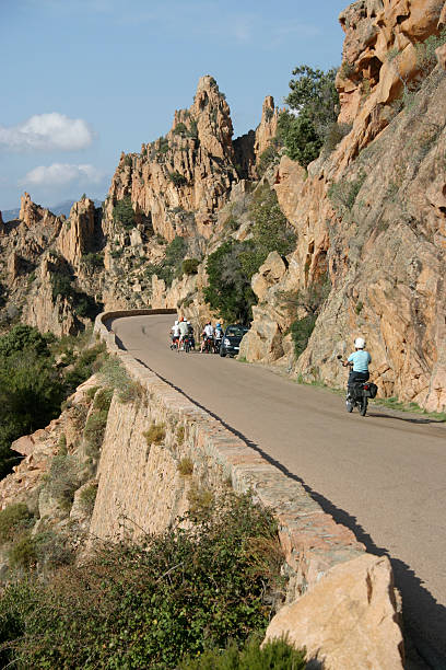 The Calanche 3 Corsica "The famous, red and orange granite outcrop, the landmark called Les Calanche, on Corsica's west coast between Piana and Porto. The narrow winding road is not for the faint-hearted, so the motorbike is a good mode of transport!" outcrop stock pictures, royalty-free photos & images