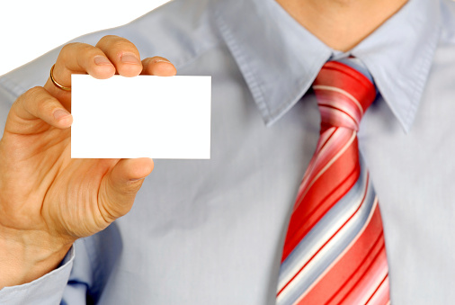 Man holding out business card. Focus on card.