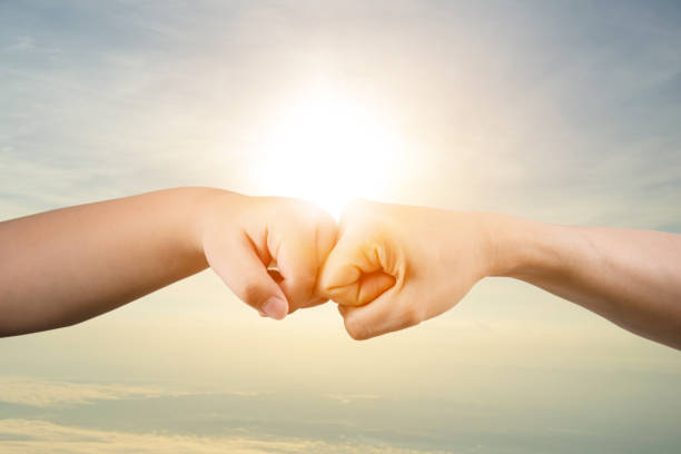 istock Fist bump concept, success, commitment to work

 Children's and adults' hands 1723703458