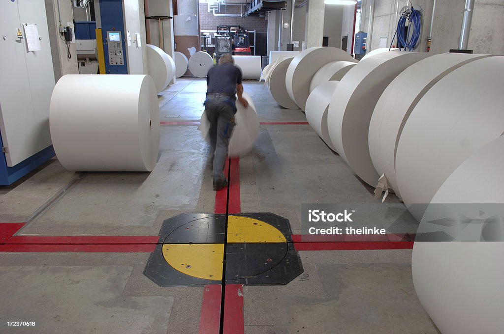 Man working in a printing office #11 Man pushing rolls of printing paper Magazine - Publication Stock Photo