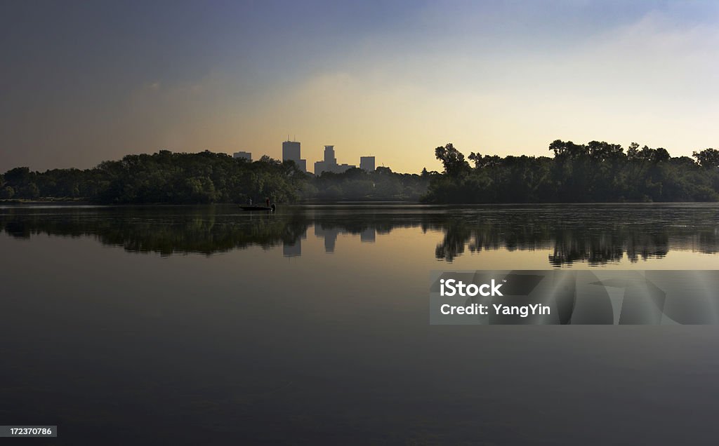 Minneapolis Lake Morning "Subject: Horizontal view across Lake of the Isles to downtown Minneapolis on a still summer morning, including an island and two people in a fishing boatLocation: Lake of the Isles, Minneapolis, Minnesota" City Stock Photo