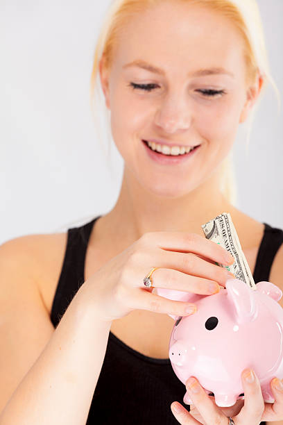 istock Young woman saving a dollar 172370990
