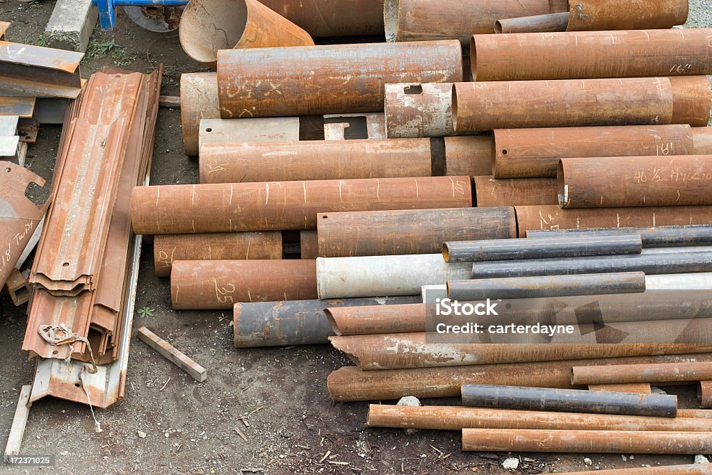 Industrial pipes A pile of industrial pipes are piled high and rusting. Lead Stock Photo