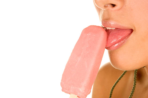istock Young woman licks pink ice cream 172371396