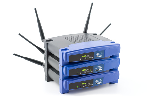 Wireless network routers (Wi-Fi) used in home and business networks. Isolated on white background with Clipping Path.
