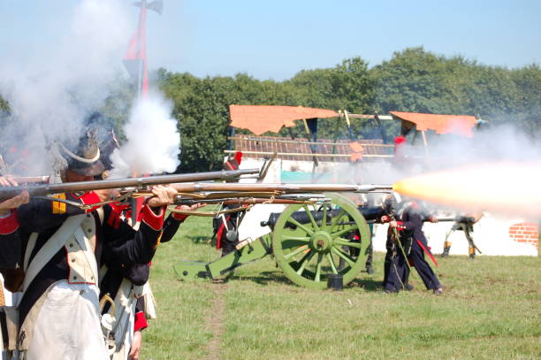 Flintlock shot. An old flintlock fires during a re-enactment battle of the Waterloo campaign. battle reenactment stock pictures, royalty-free photos & images