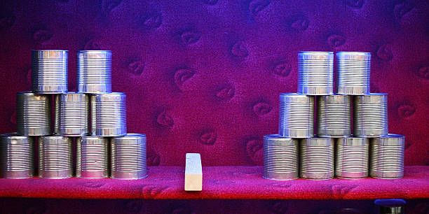 istock Two pyramids of empty cans at attraction on a fair 172372829
