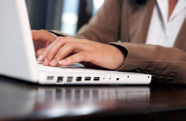 typing on a laptop stock photo