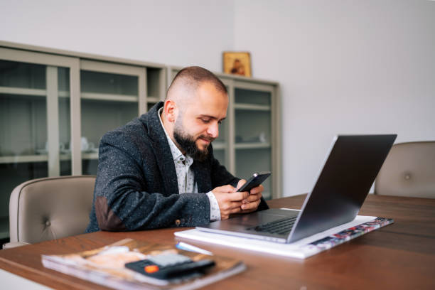 istock Stressed businessman using phone in his office 1723737380