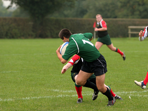 Rugby, action and man kicking ball to score goal on field at game, match or practice workout. Sports, fitness and motion, player running to kick at poles on grass with energy and skill in team sport.