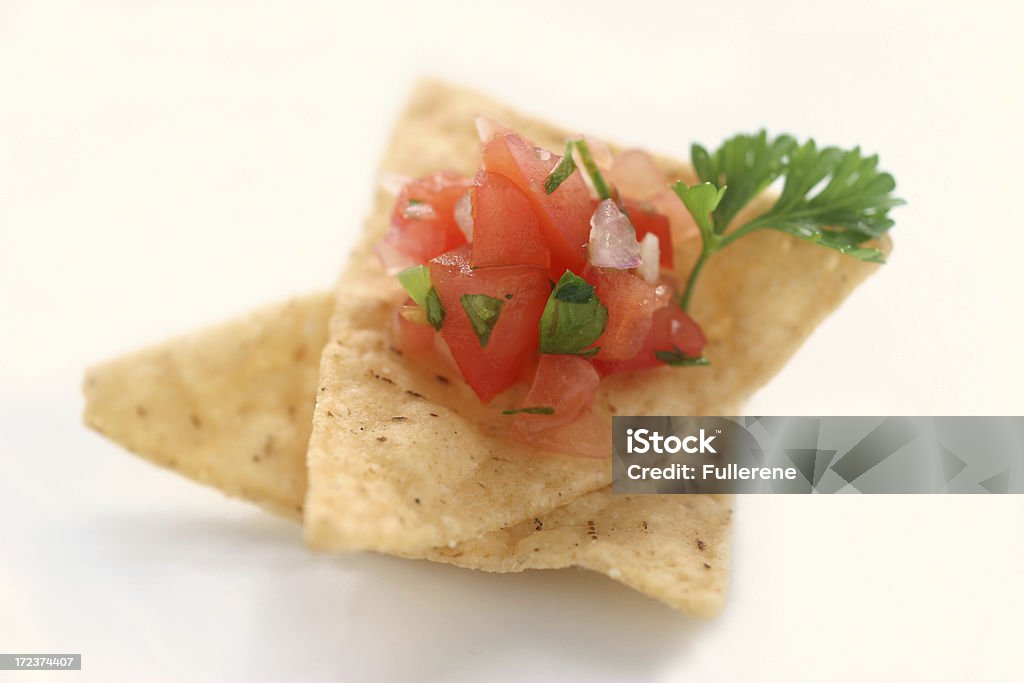 chips and salsa macro of two corn chips and fresh salsa.  Shallow dof Appetizer Stock Photo