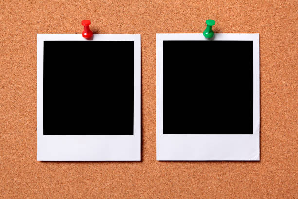 istock Two blank photos pinned to a cork board 172374756