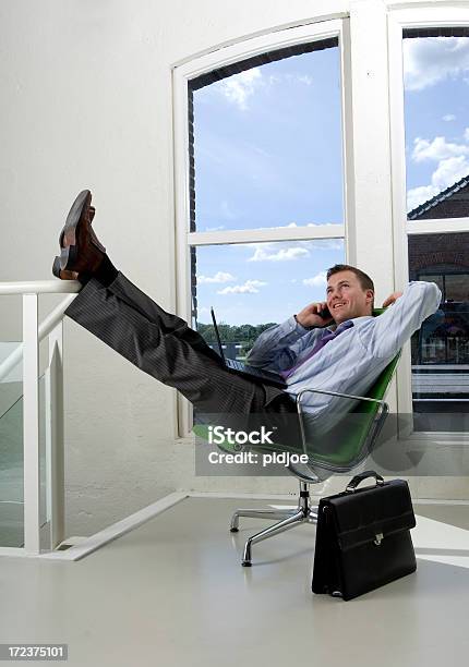 Relaxed Businessman Phoning Stock Photo - Download Image Now - Office, Feet Up, Wall - Building Feature