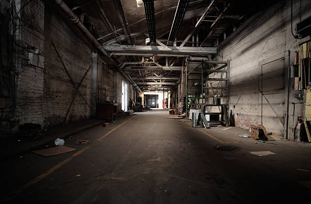 Uninviting and dark warehouse hall stock photo