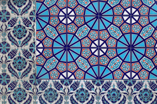 Traditional tile pattern in Morocco. Delicately crafted turquoise tiles form a floral-geometric pattern.